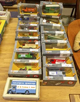 Boxes of Corgi model trucks, vans and other vehicles on display at auction
