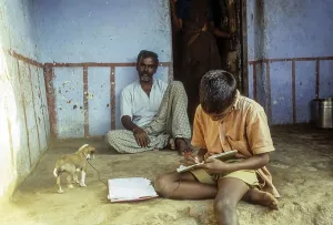 A boy doing his homework in the sit out at Courtalam Kutralam Kuttalam