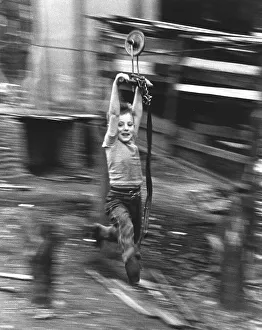 Boy hangs on wire rope, England, Great Britain