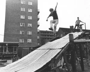 Boy plays on tin slide, England, Great Britain