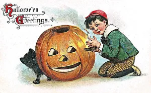 Boy and pumpkin with a carved face