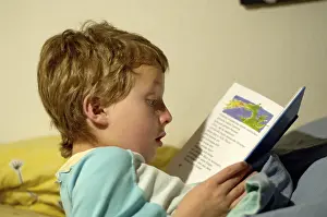 Boy reading in bed