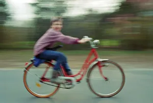 Boy riding bicycle, motion blur