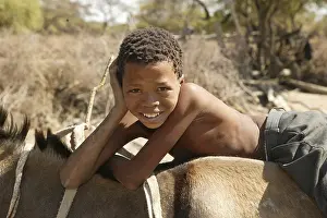 Boy riding on donkey, Cattlepost Bothatoga