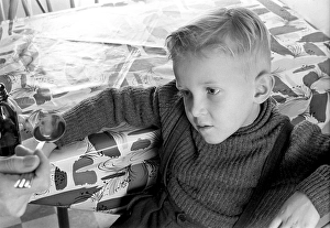 A boy is sick and won't take his medicine