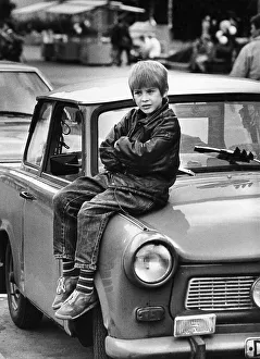 A boy sits on Trabant 601, East Europe, circa 1988