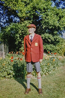 Boy standing in the garden wearing a brand new school uniform, England, Great Britain, 1960s, Full-length portrait