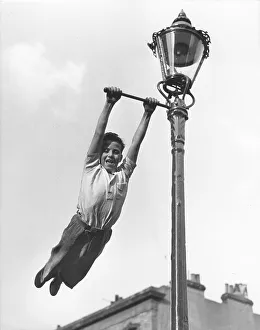 Boy swings to Lantern, England, Great Britain