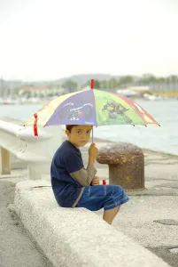 Boy with umbrella at pier, Pesaro, umbrella, Italy