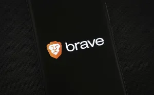 Brave logo is displayed on a smartphone screen