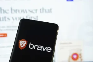 Brave logo is displayed on a smartphone screen