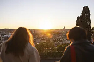 A breathtaking sunset casts a warm glow over Rome's iconic skyline