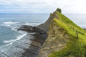 Breathtaking view of the flysch cliffs meeting the ocean waves at sakoneta beach