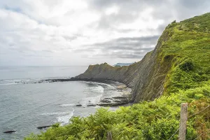 Breathtaking view of the flysch cliffs meeting the ocean waves at sakoneta beach in zumaia