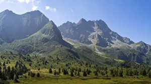 A breathtaking view of a towering mountain range with rugged peaks