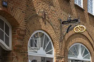 Brick building with bakery and wrought-iron sign