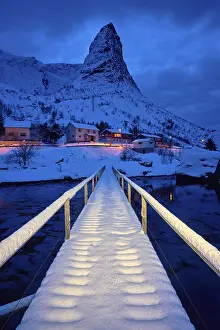 Bridge in Reine village covered with snow at night