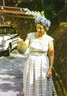 British expatriate woman holding a durian fruit