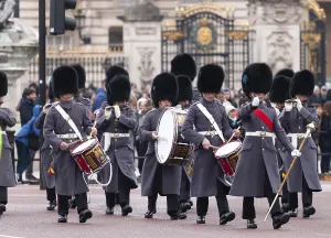 British guards in ceremonial dress marching with drums near Buckingham Palace in the City of Westminster