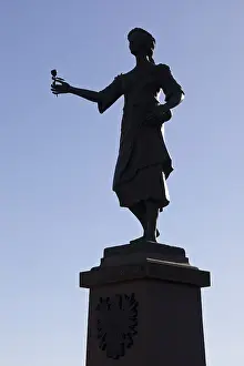 Bronze monument to the Roman goddess Flora with a rose
