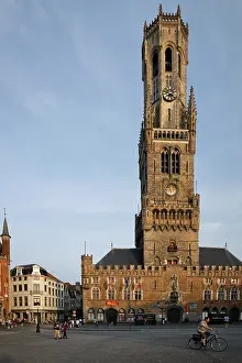 BRUGES, BELGIUM, MAY 28, 2018: Belfry tower famous tourist destination and Grote markt square in Bruges