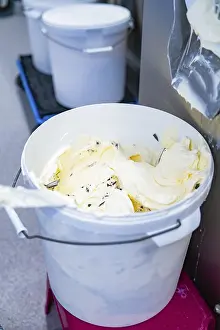 A full bucket of vanilla ice cream with chocolate chips from the production