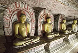 Buddha figures inside Dambulla cave Buddhist temple complex