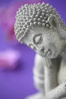 Buddha Figurine On A Purple Background