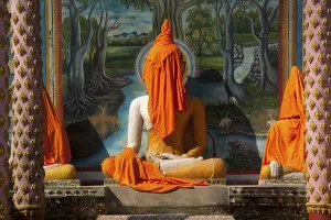 Buddha statue covered with orange fabrics