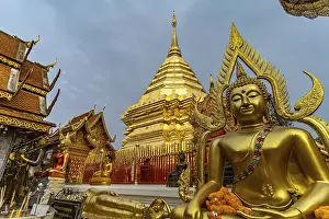 Buddha statue and Golden Chedi of the Buddhist temple complex Wat Phra That Doi Suthep