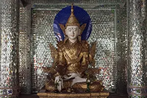 Buddha statue inside a shrine with mirror mosaic