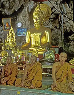 Buddha statue, monks praying, Wat Tam Sua monastery near Krabi