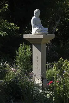 Buddha statue on a stone pillar in the garden