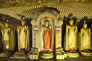 Buddha statues and murals in one of the cave temples of the Golden Temple