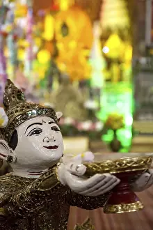 Buddhist angel holding a bowl of coins