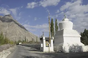 Buddhist chorten with a very long Mani wall beside the road in the Hundar oasis