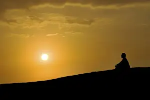 Category Buddhism Prints: Buddhist meditating at sunset