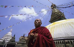 Buddhist monk prays at the Monkey Temple or Swayambhunath