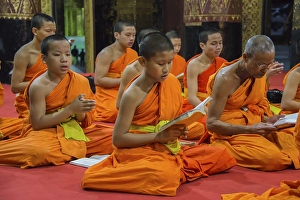 Category Buddhism Prints: Buddhist monks praying in the temple Wat Xieng Thong