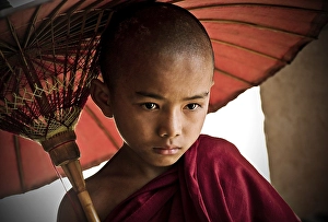 Category Buddhism Prints: Buddhist novice holding an umbrella