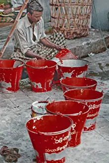 Burmans with red firefighting buckets