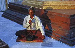 Burmese meditating with a rosary in the Shwedagon Pagoda
