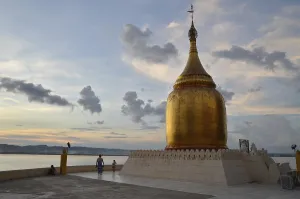 Category Buddhism Prints: Burmese visitors and pilgrims at the gilded Bupaya Pagoda on the Ayeyarwady river at dusk