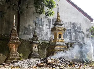 Burning waste at the ossuary at a Buddhist monastery Wat Si Sou Mang