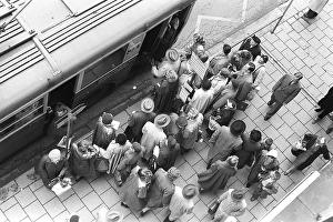 Bus stop in Stockholm in 1953. People are waiting for the bus at the bus stop. Bus 32 travelling on the Fleminggatan-Fridhemsplan line has stopped and people have started to get on the bus