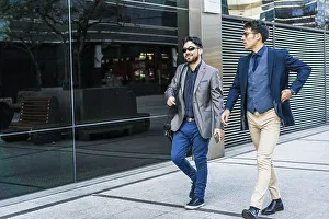 Two business colleagues are talking while walking on the street