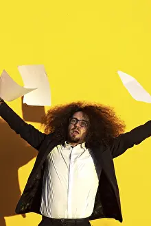 Business man throwing documents in the air on isolated background