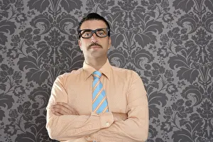 Businessman nerd portrait with retro glasses over wallpaper background