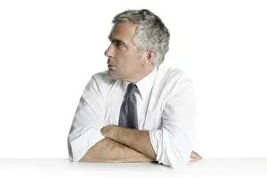 Businessman senior profile relaxed sit portrait white desk background