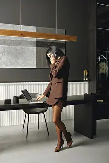 A businesswoman stands in a modern office space
